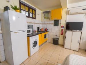 a kitchen with a refrigerator and a washing machine at Studio confortable au Lamentin - idéal séjour pro ou découverte in Le Lamentin