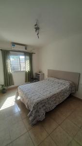 a bedroom with a bed in a room with a window at M&P alquiler por día in La Rioja