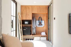 a living room with a couch and a closet at ฉันฉาย bed&restaurant in Ban Na Sai