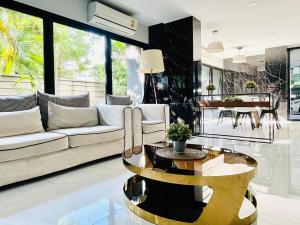 a living room with a couch and a table at Best Quiet Cozy Palm Springs Condo in Center Nimma in Chiang Mai