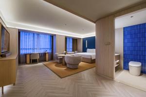 Ένα ή περισσότερα κρεβάτια σε δωμάτιο στο Crystal Orange Shanghai Lujiazui Financial Center Hotel