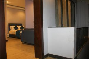 a living room with a couch and a bed at Studio 509 in Kandy