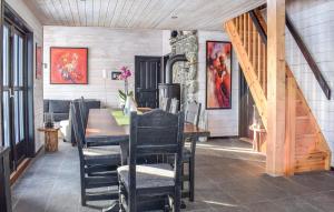 a dining room with a table and chairs at Amazing Home In Jøsenfjorden With Sauna in Gullingen