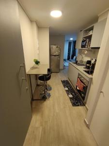 a small kitchen with a table and a counter at Movistar Arena - Fantasilandia - Apartment Parking in Santiago
