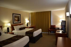 a hotel room with two beds and a flat screen tv at Inn on Long Lake in Nanaimo +71 photos