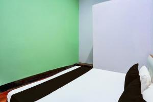 Ένα ή περισσότερα κρεβάτια σε δωμάτιο στο Hotel O Laddu Hotel