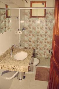 a bathroom with a sink and a toilet at Hotel Fazenda Coninho in Inhaúma