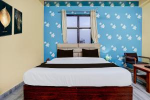 Postel nebo postele na pokoji v ubytování Super Hotel O Nand Palace