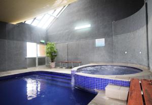 a large swimming pool with a large tub in a building at Arlberg Hotham in Mount Hotham