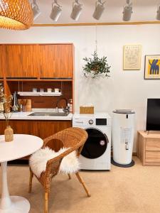 a kitchen with a washing machine and a table at 18 Hongik Univ Best location city view in Seoul