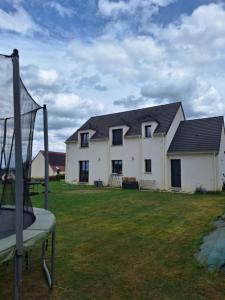 a house with a playground in front of it at Belle Maison Récente in Neauphle-le-Château