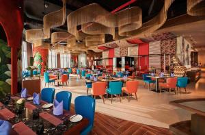 a restaurant with tables and chairs in a room at LYN Panorama Nha Trang Condotel in Nha Trang
