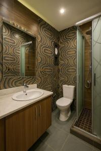 a bathroom with a toilet and a sink and a shower at Elegant Sea View Chalet with Private Balcony in Port Said