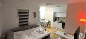 a living room with a couch and a kitchen at City apartman Modrica in Modriča