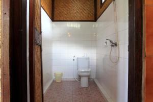 a bathroom with a toilet and a shower at Bella House Monkey Forest in Ubud