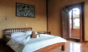 a bedroom with a large bed in a room at Bella House Monkey Forest in Ubud