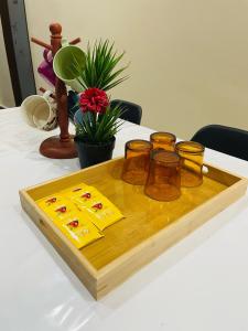 a wooden tray with four glass jars on a table at Utaqha Ventures Homestay in Seri Manjung