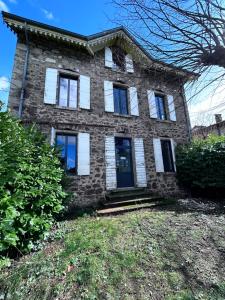 a large brick house with white shutters on it at Maison 1880 in Annonay