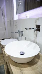 a bathroom with a white sink and a mirror at P & K Design LTD Flats in Nea Moudania +11 photos