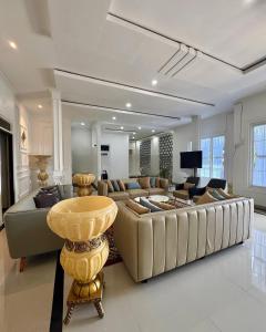 TlekungにあるVilla putih 10 kamarのソファとテーブルのある広いリビングルーム