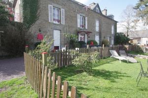 a wooden fence in front of a house at Le domaine de la belle Normandie in Condé-sur-Noireau +8 photos