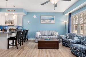 a living room with a couch a table and a kitchen at Harbor Hideaway 1 Block to Beach AC in Hampton