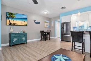 a living room with a kitchen and a dining room at Harbor Hideaway 1 Block to Beach AC in Hampton