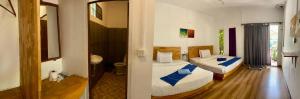a hotel room with two beds and a mirror at Sweet Time Bungalows in Koh Rong Sanloem