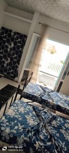 two beds sitting in a room with a window at Résidence Dar Baba in Skikda