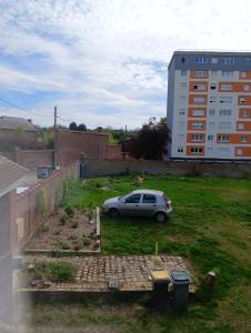 a car parked in the yard of a building at Maison partagée - Studio bas in Beauvais
