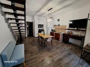 a living room with a wooden table and a kitchen at La Casetta in Canadà Agerola Amalfi Coast in Agerola