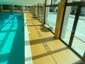 a swimming pool in a building with a view of it at Moggio terrazzo 24 in Cremeno