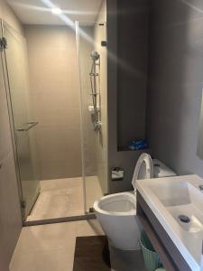 a bathroom with a shower and a toilet and a sink at Luxury condo - BTS Punnawithi - Pool, Gym, Sauna in Amphoe Phra Khanong