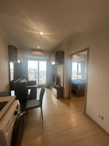 a living room with a room with a bed and a kitchen at Luxury condo - BTS Punnawithi - Pool, Gym, Sauna in Amphoe Phra Khanong
