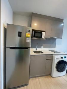 a kitchen with a stainless steel refrigerator and a dishwasher at Luxury condo - BTS Punnawithi - Pool, Gym, Sauna in Amphoe Phra Khanong +28 photos