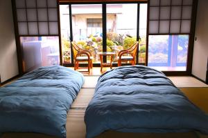 Postel nebo postele na pokoji v ubytování 民泊-和-Guesthouse-wa-