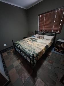 a bedroom with a bed in a room with a window at Nerina 662 in Leeupoort