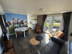 a living room with a couch and a table at Camping Wad noch Meer in Anna Paulowna