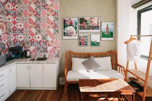a living room with a chair and a sink at Ngàn Phố Studio & Love Hotel in Da Lat