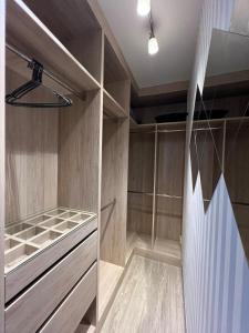 a walk in closet with wood paneling and a ceiling at Modern Condo - BTS Bang Chak - Pool, Gym, Wi-Fi in Amphoe Phra Khanong