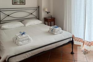 a bedroom with a bed with towels on it at Villa Rossi in Polignano a Mare
