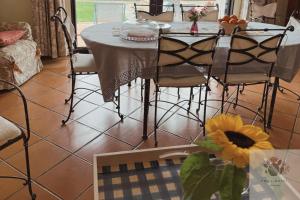 a dining room with a table and some chairs at Villa Rossi in Polignano a Mare