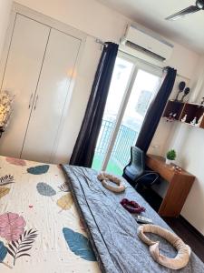 a bedroom with a bed with a large window at Harmony Heights By Royal Rooms in Noida +4 photos