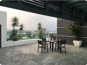 a table and chairs on a balcony with a view at GA Homes Homestay - Majestic Ipoh Condo in Ipoh