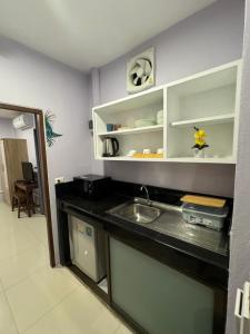 a kitchen with a sink and a counter top at Pupa Rooms in Patong Beach +64 photos