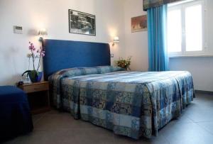 Postel nebo postele na pokoji v ubytování Albergo Rossella