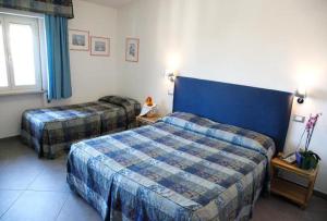 Postel nebo postele na pokoji v ubytování Albergo Rossella