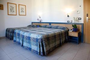 Postel nebo postele na pokoji v ubytování Albergo Rossella