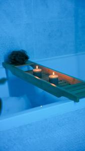 a table with three candles in a swimming pool at Tropical Jungle in Béziers