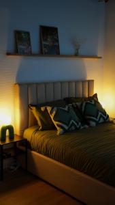 a bed in a room with a night stand next to it at Tropical Jungle in Béziers +12 photos